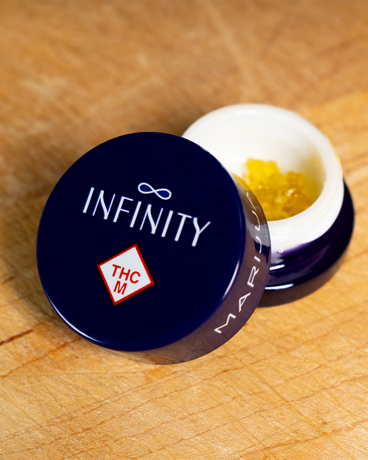 a jar of infinity live sugar is open with the concentrate peaking out