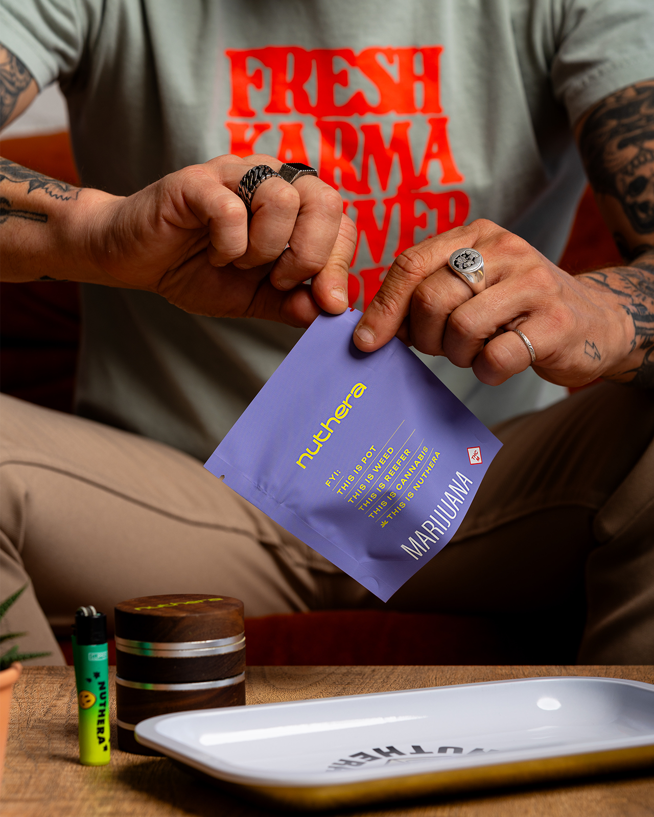 A pair of hands rips open a purple nuthera flower packaging.